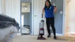 Touch of Europe cleaner vacuuming bedroom floor